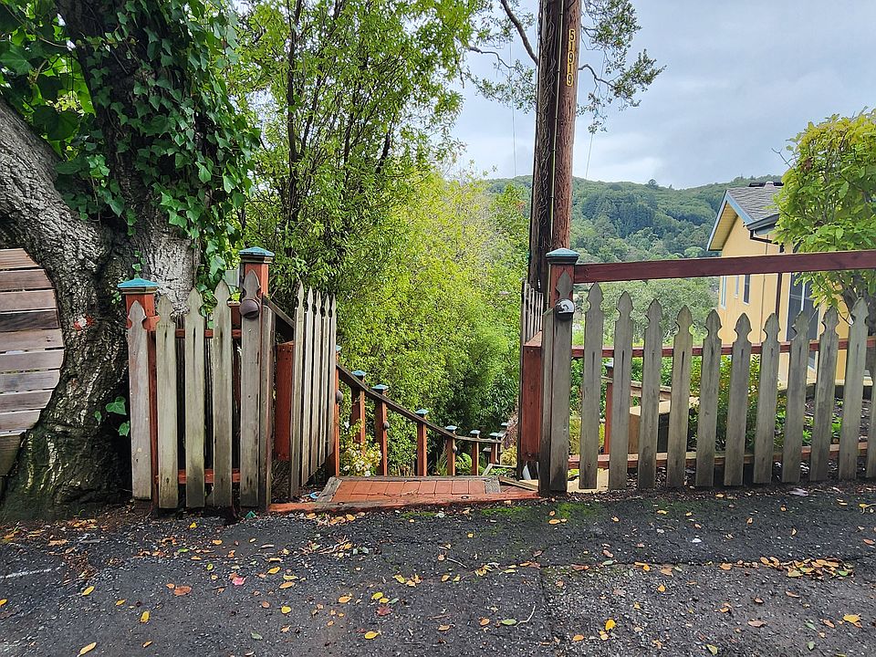 Double wide gate with lights along fence towards street
