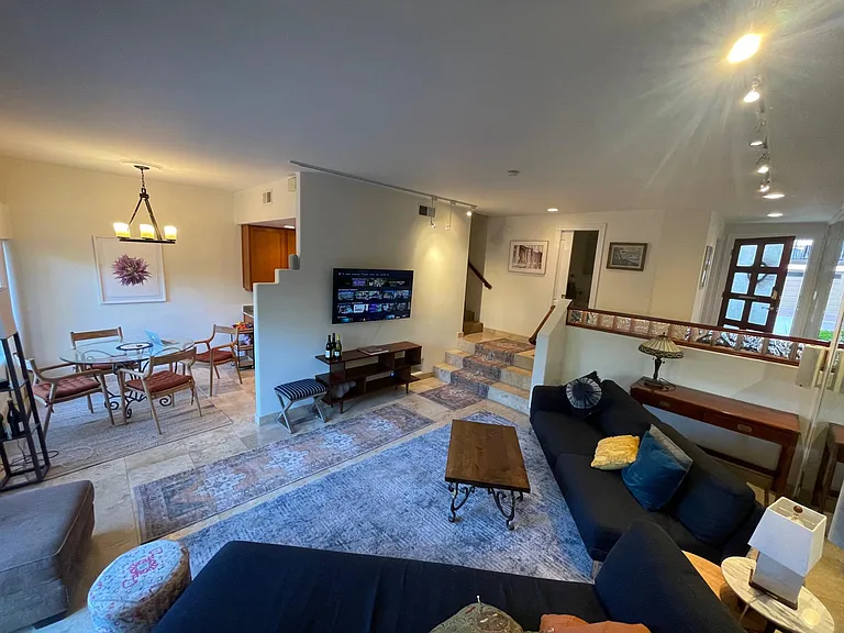 Living Room with Dining Room and Entry. The door to the two car garage is to the left of the front door. One guest parking pass is supplied.