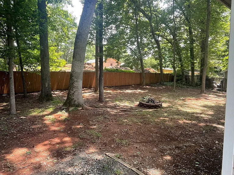Back Yard with Fire Pit and stained Fence.