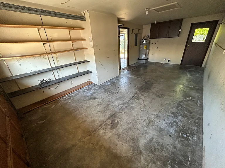 1 car garage with shelving, washer-dryer hookups and door to backyard