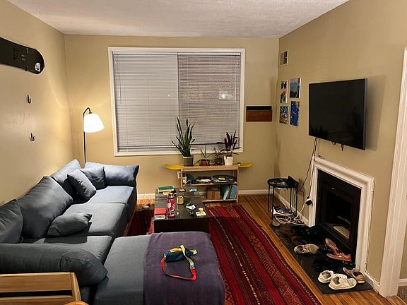 Living room with view to front window, fireplace and cable wiring.