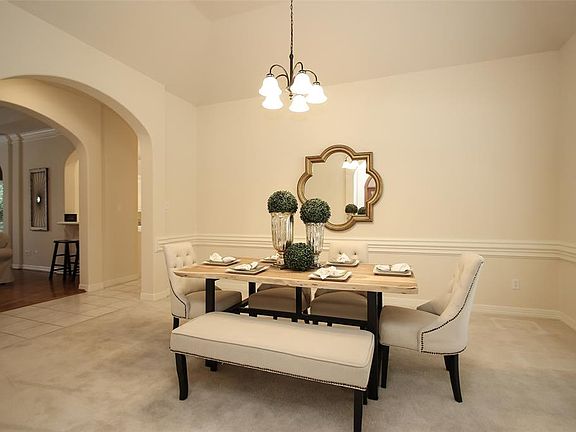 Dining Room with raised ceiling and chair rail molding and a huge window to let in the natural light.