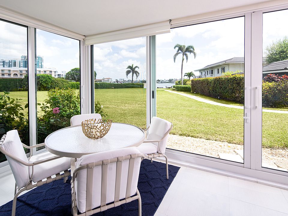 one side of the lanai that looks out at the expansive back yard and Naples Bay