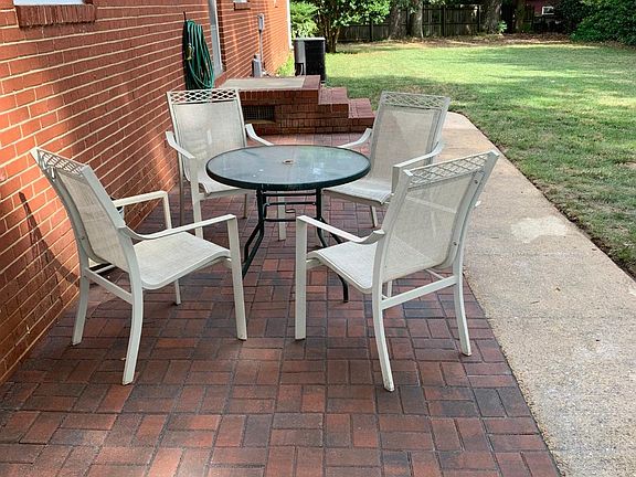 Backyard with fence on 3 sides and new HVAC and patio. Table and 4 chairs can remain at property for tenant usage.