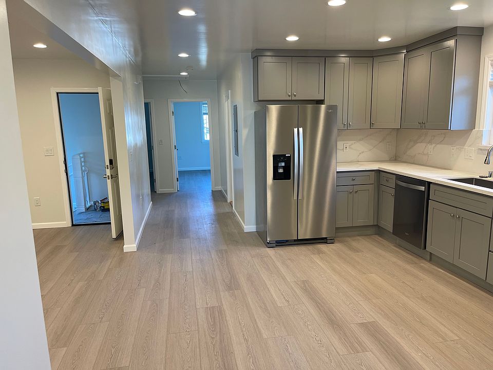 newly remodeled kitchen with new countertops, cabinets, refrigerator, and dishwasher