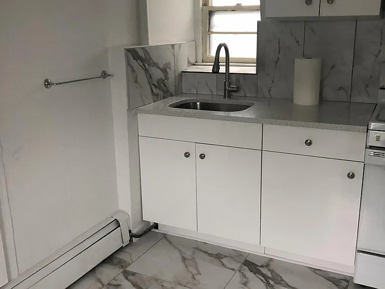 Sunny and bright new kitchen with beautiful tiled floor.