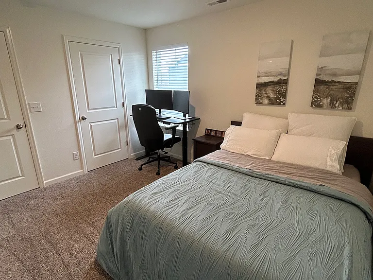Guest Bedroom 2 - with work station and queen bed and closet door on the right