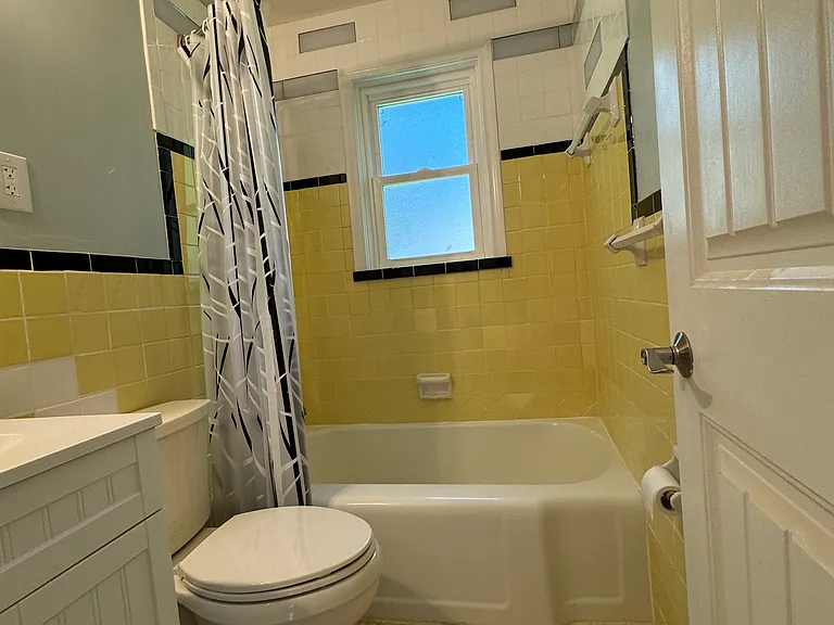 1st floor bath, tiled to ceiling.