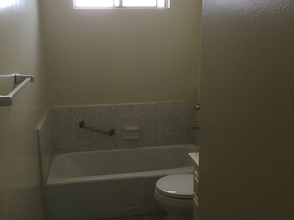 Bathroom has tub and separate shower