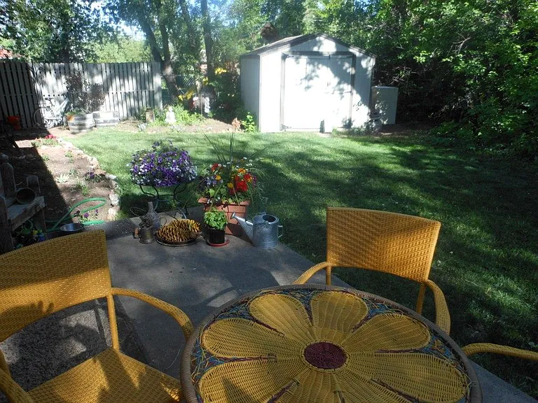 Private, fenced back yard with large storage shed.