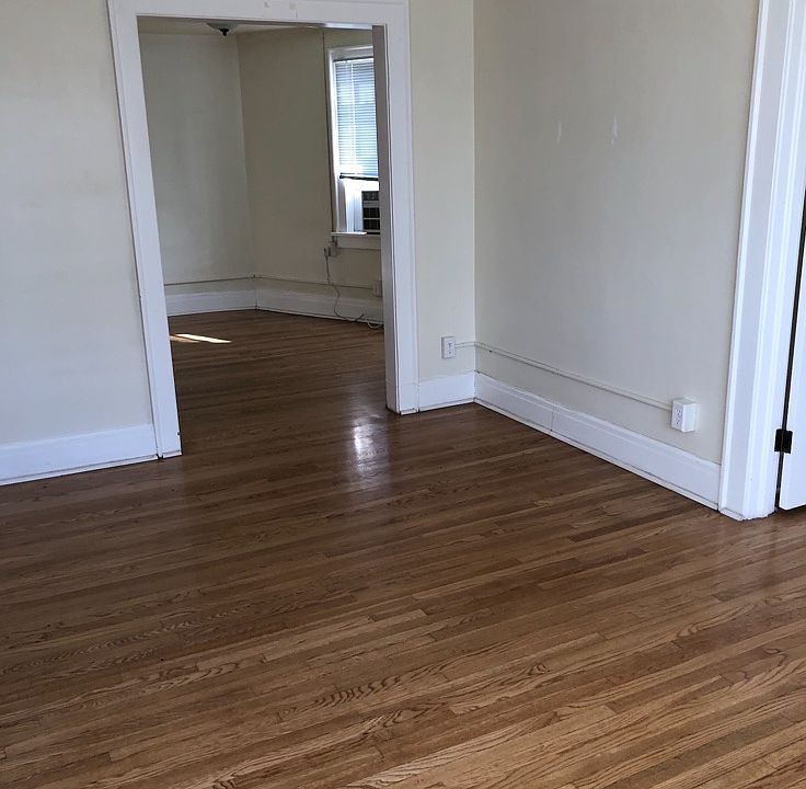 Looking from the front of the living room towards the dinning room. The bedroom is on the left.