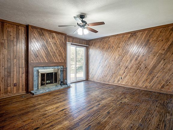 Italian marble fireplace and pecan wood paneling
