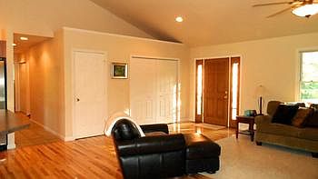 Vaulted ceilings in the living room offer a grand entry.