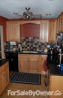 Kitchen : New, custom-made maple wood cabinets with tile back-splash.