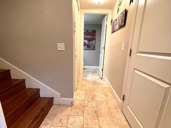 Entry hall. Garage door to right. Half bath straight ahead, 6 stairs to main level to left. Coat closet to left