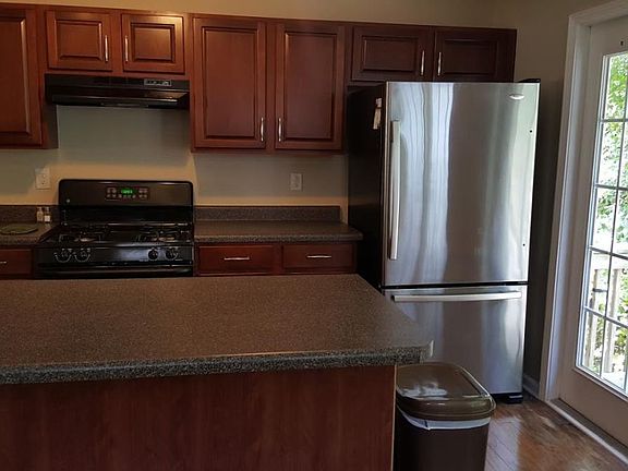 Kitchen with cherry cabinets and extra large refrigerator