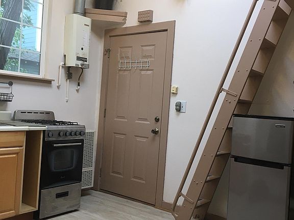view from window seat to entry door and stove