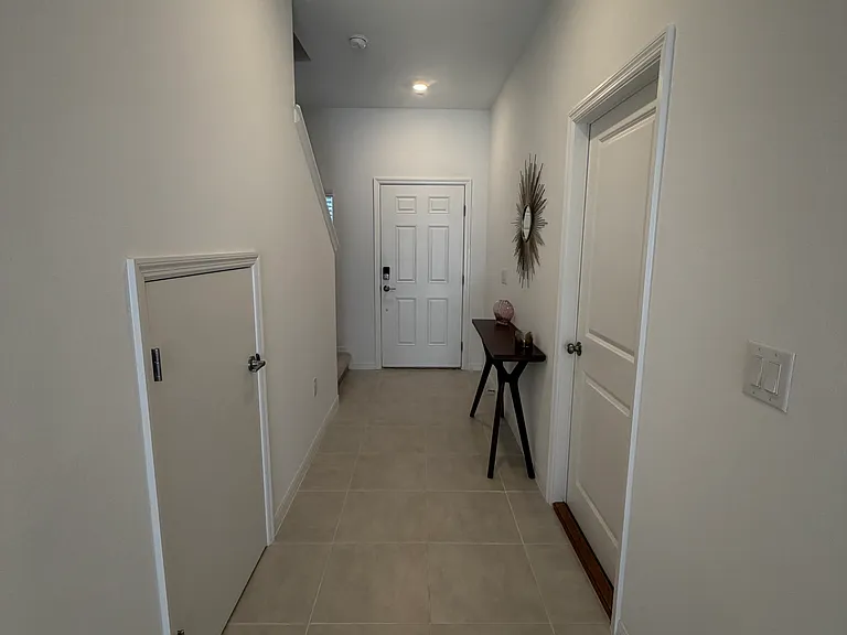 Under stairs storage and garage entry.