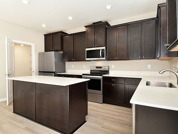 Kitchen with stainless steel appliances and plank flooring
