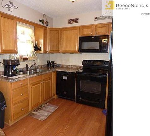 Kitchen features wood floors and pantry