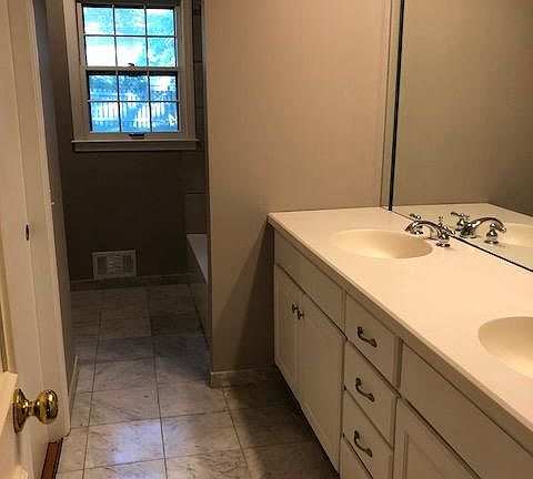 Hall bath with tub& shower, 2 sinks, marble floor