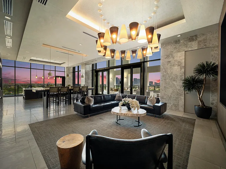Resident lounge and entertaining kitchen, featuring breathtaking views of downtown Houston