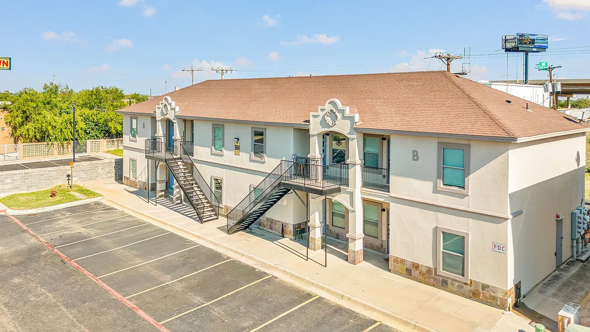 Exterior view of Merida Vista Apartments in Laredo, Texas, located at the corner of a parking lot - 109 N Merida Dr
