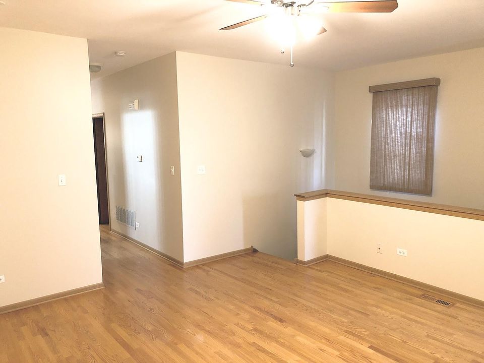 Large living room is hardwood, stairs lead to basement bedroom and more