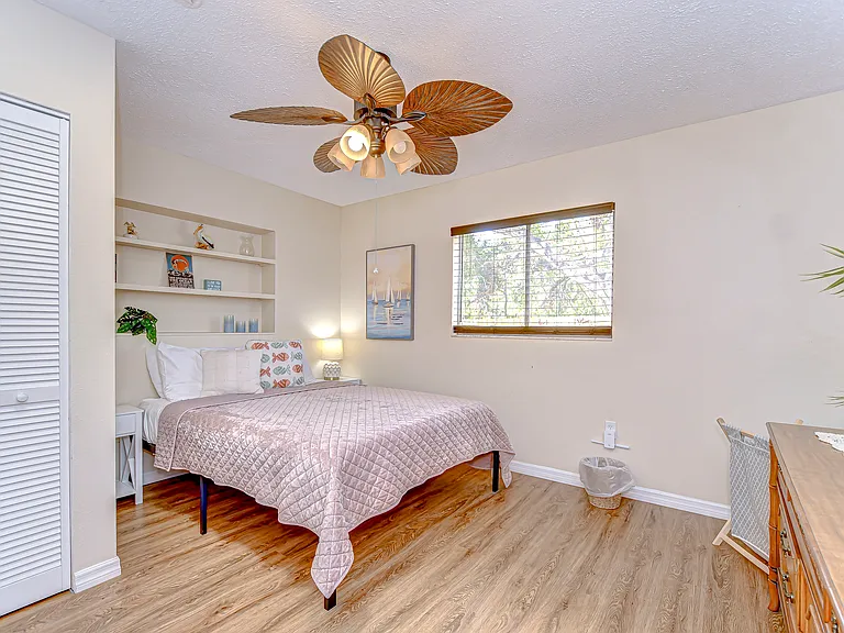 The bedroom features a queen bed and a smart tv