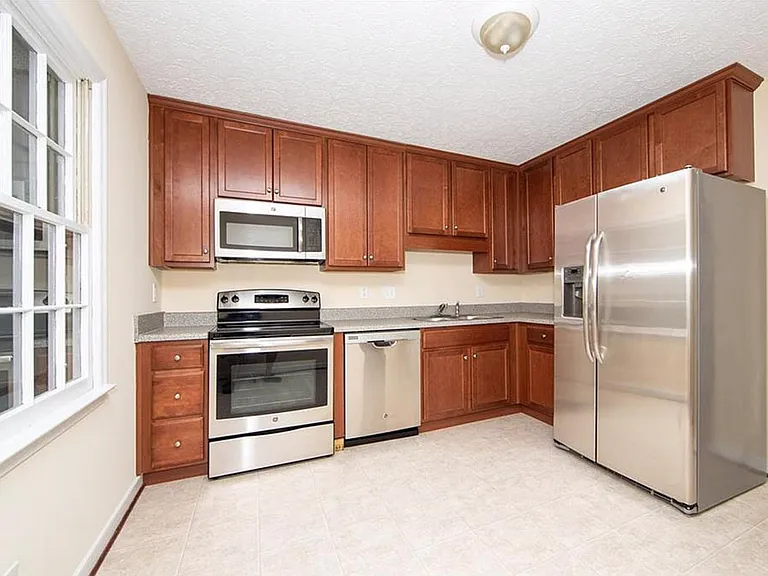 Kitchen with stainless appliances: refrigerator, stove, microwave and new dishwasher in 2024 (not pictured).