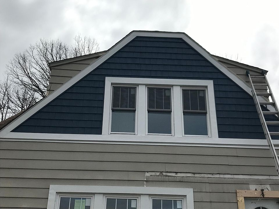 In progress pic - exterior to be painted blue (like the shaker siding) and new porch cover being built.
