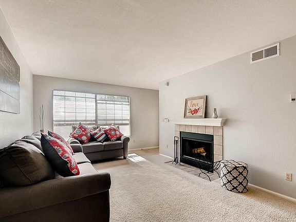 Light-filled living room with cozy fireplace.