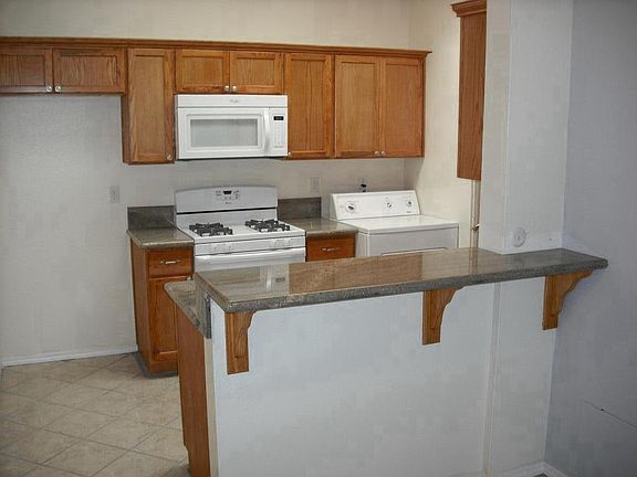 Fridge space, Microwave, stove and dryer area. 
