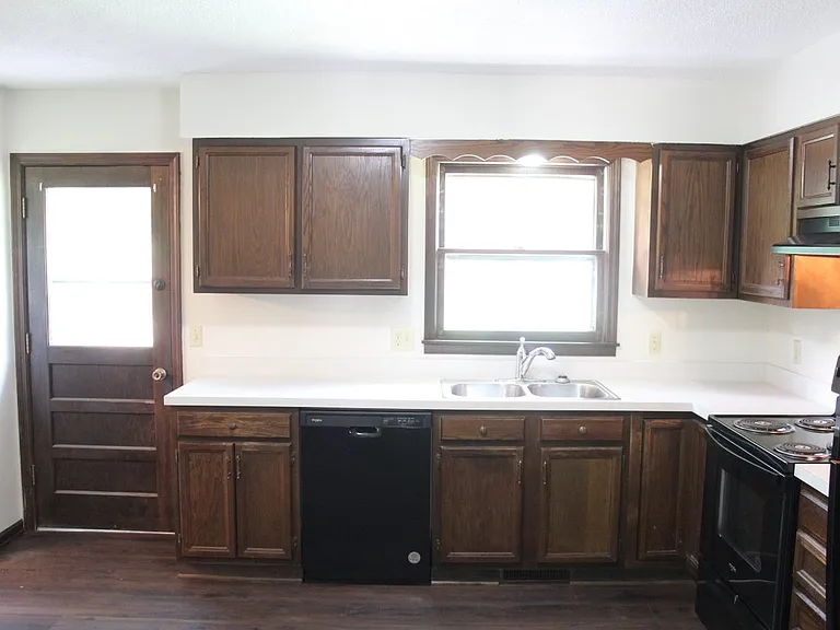 Furnished dishwasher, Double Kitchen sink with a garbage disposal. Back door to the outside patio. Nice for grilling.