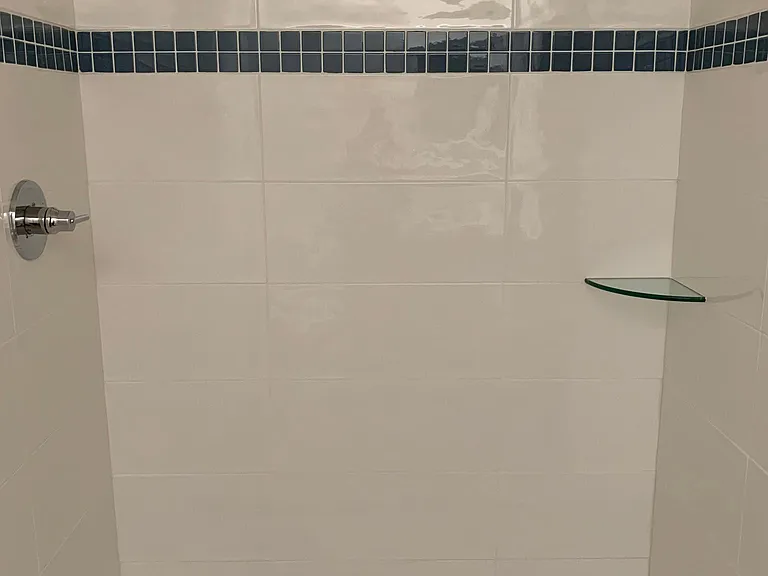 Brand new shower. Marble floor with high end modern shower head.