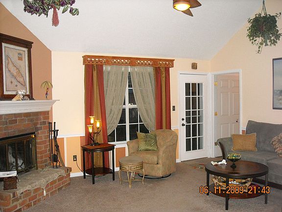 View from Entry, Inviting Living Area, Lg Windows to Covered Patio/Back Yard.