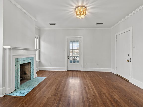 The closed door on the right leads into the central hallway of the building. The glass door leads to the balcony.