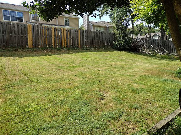Fenced , grassed backyard