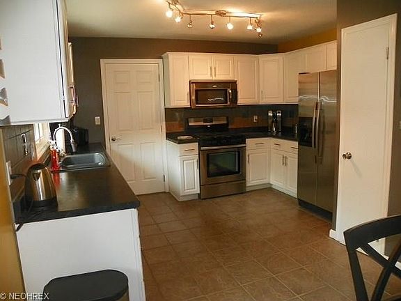 ceramic floored kitchen with stainless steel appliance package Designed for convenience