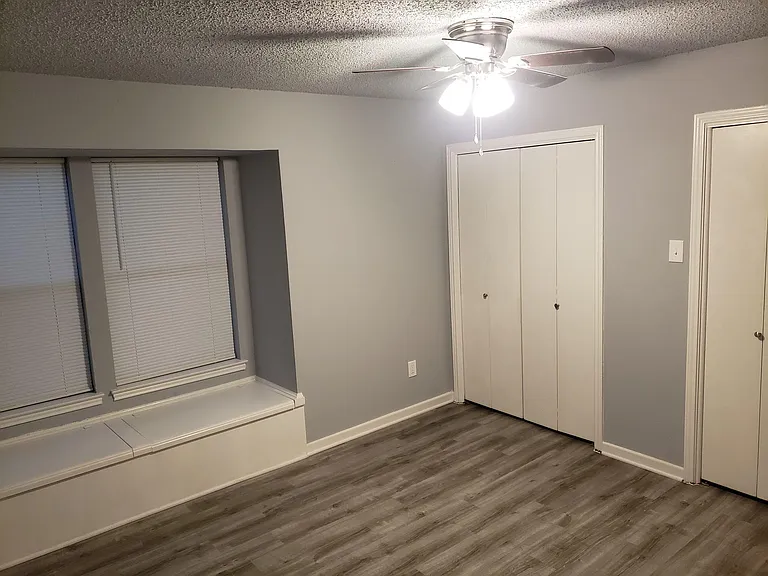 Bedroom 2 (mirror image of Bedroom 1) with window seat storage and 2 closets