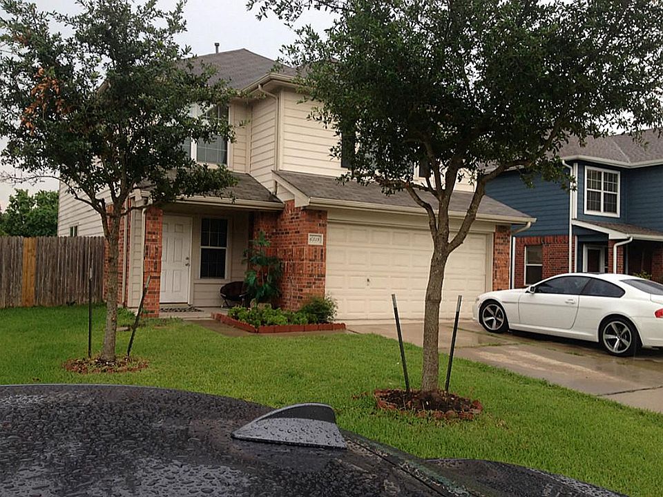 Front of the House with trees and nice landscaping.