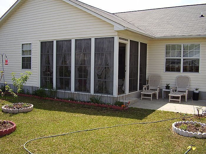 View of enclosed finished porch and terrace , as seen from backyard