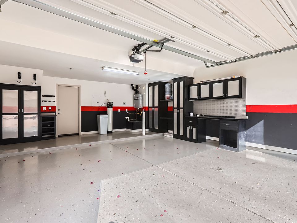 spacious and upgraded 2 car garage with tons of storage and workbench. Features tankless water heater and whole house water softening system.