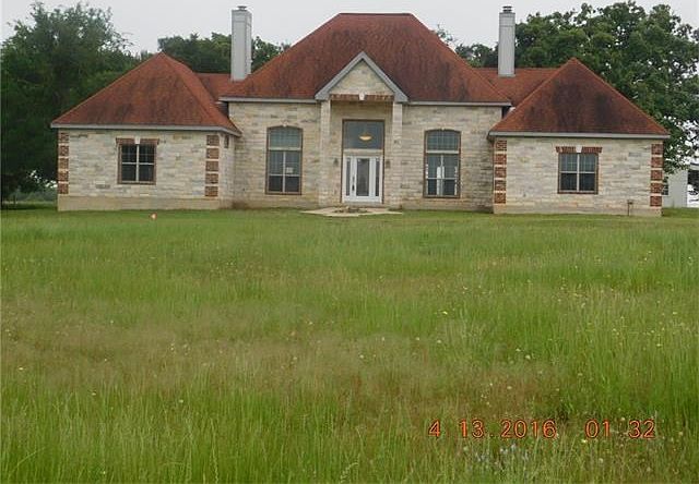 Front view from driveway N View elegant home with 2 fireplaces all stone exterior
