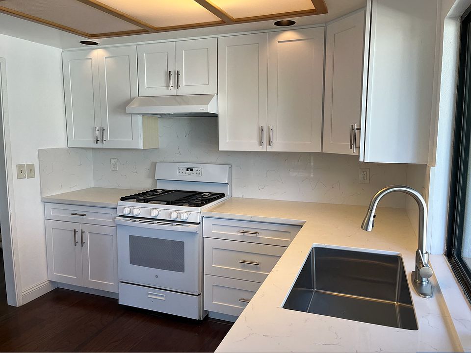 Newly renovated kitchen with brand new cabinets, countertops, and modern appliances.