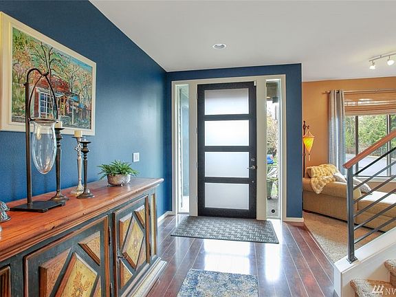 The gorgeous entry door is tall and elegant, and features frosted glass panels which bring in abundant light.