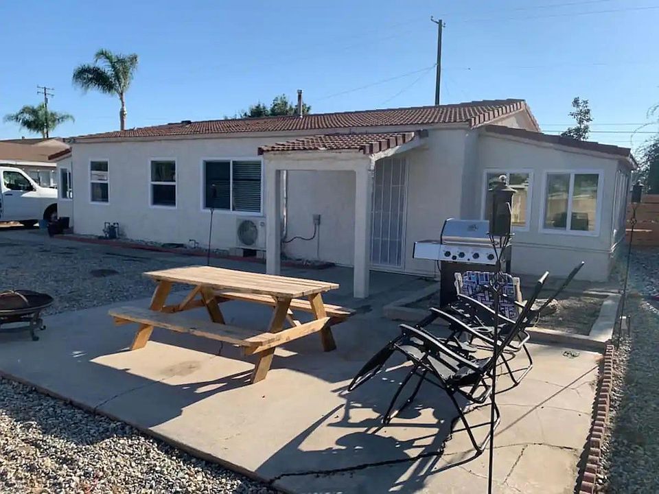 Outside Patio, Fire pit with BBQ with the home in the background.