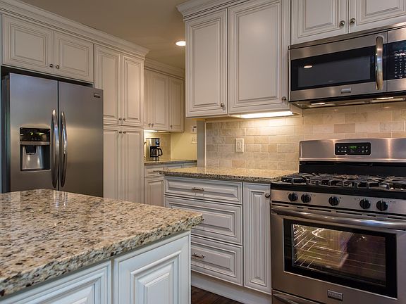 Kitchen cabinetry; marble backsplash close up