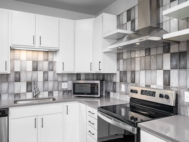 Sleek modern kitchen with stylish gray tile backsplash, stainless steel appliances, and crisp white cabinets for a contemporary look. Sleek modern kitchen with stylish gray tile backsplash, stainless steel appliances, and crisp white cabinets for a contem