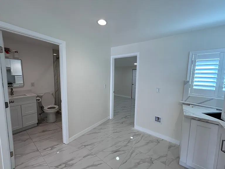 View from Kitchen: of Bathroom 1 (left), and entrance to Bedroom 3 (center)
